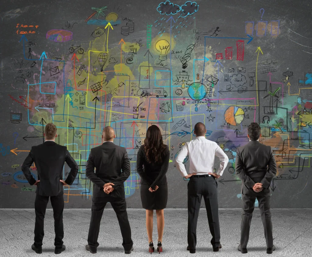 Navigare le Sfide di Mercato 7 Sfide di Mercato gruppo di persone che guardano un grafico sulla lavagna grandissima