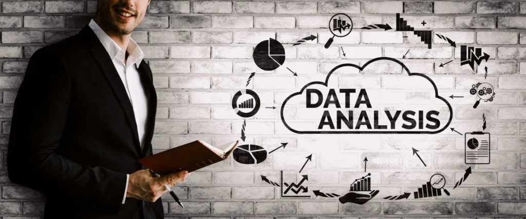 Importanza dei Dati nel Decision Making 2 Dati nel Decision Making ragazzo con quaderno in mano e dei grafici sulla parete di fondo